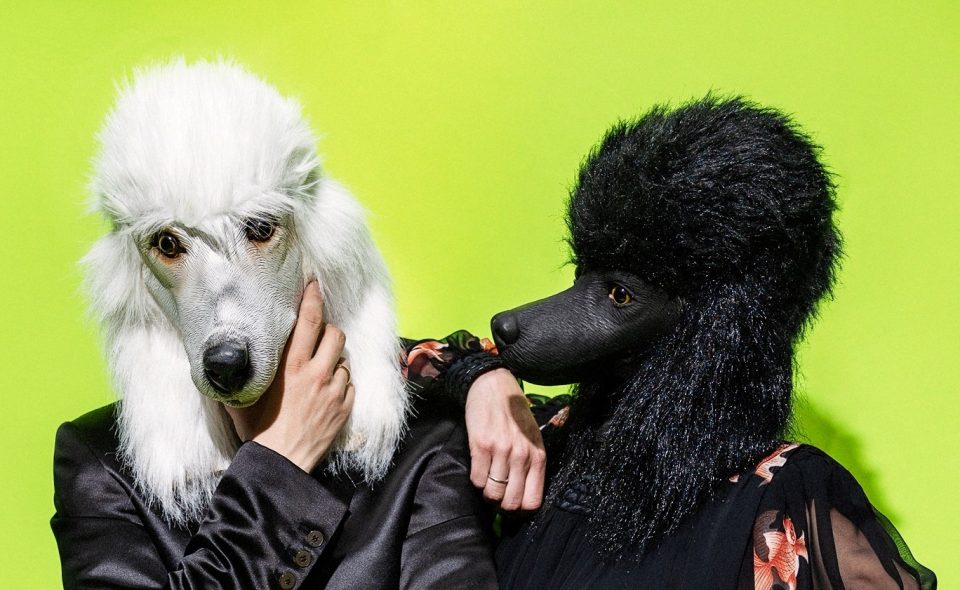 Two person with poodle dog masks over head