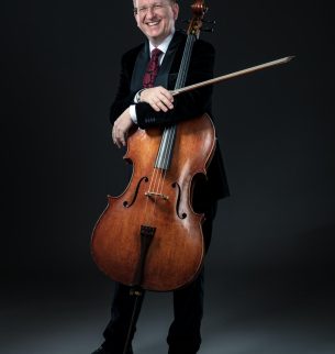 Mann mit Cello vor schwarzem Hintergrund